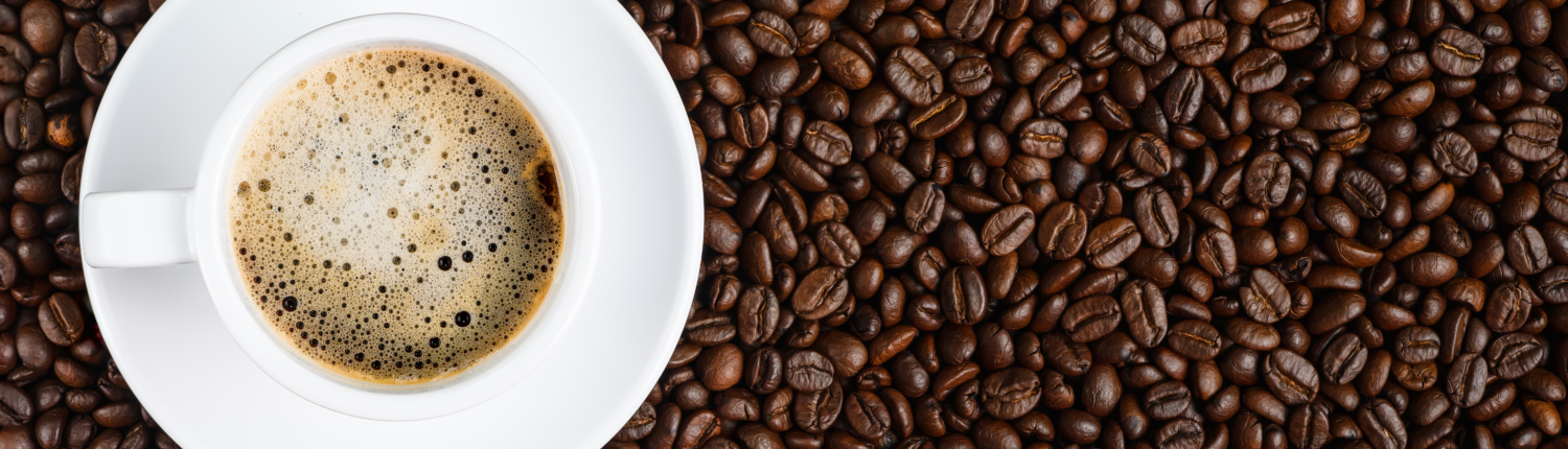 panoramic coffee background of a cup of black coffee covered wit